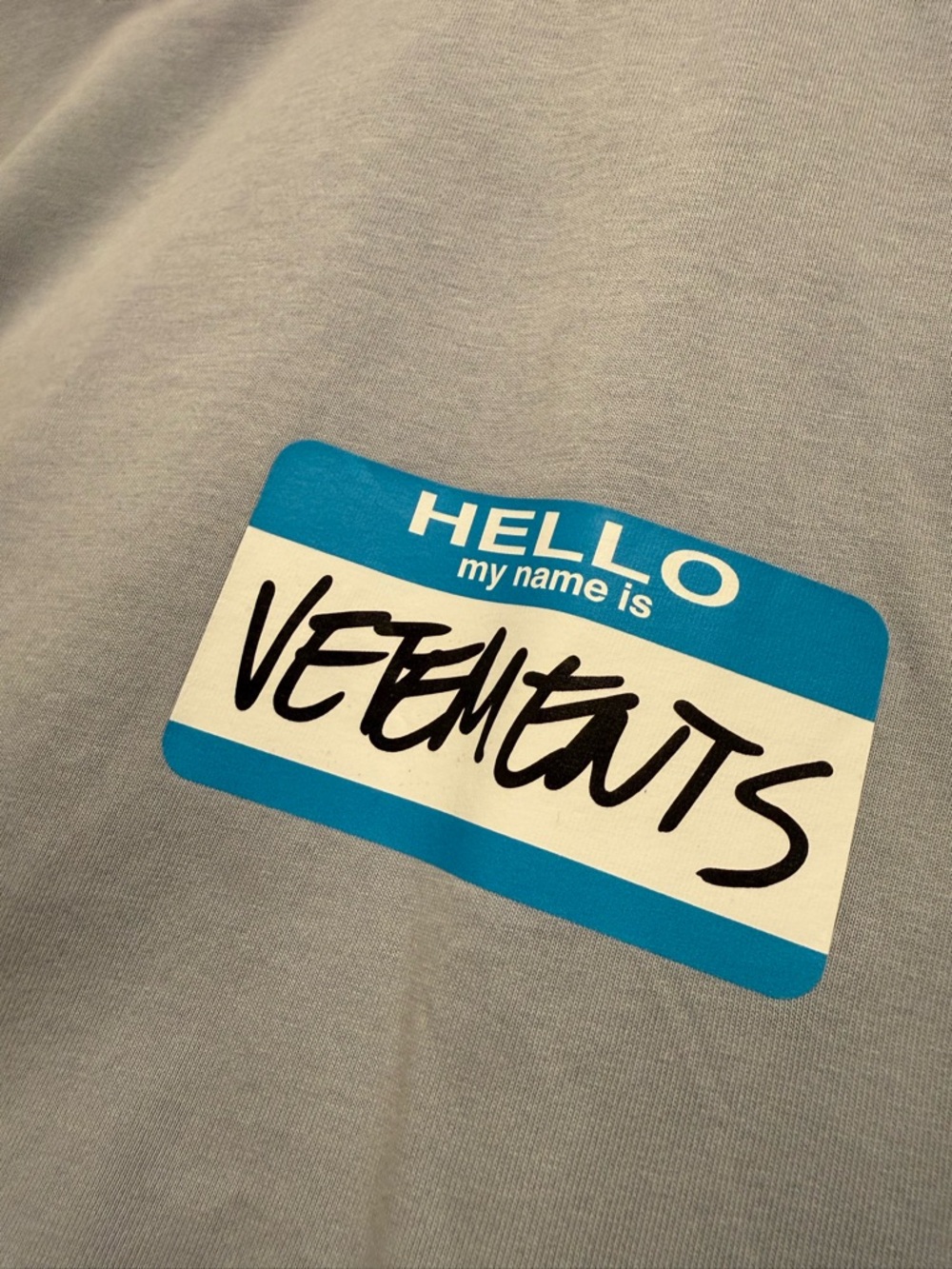 Vetements Light Gray Tee with Blue 'Hello My Name Is' Graphic